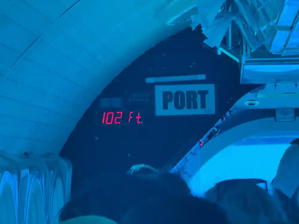 The depth display reading 102 feet beside the PORT sign in the cabin