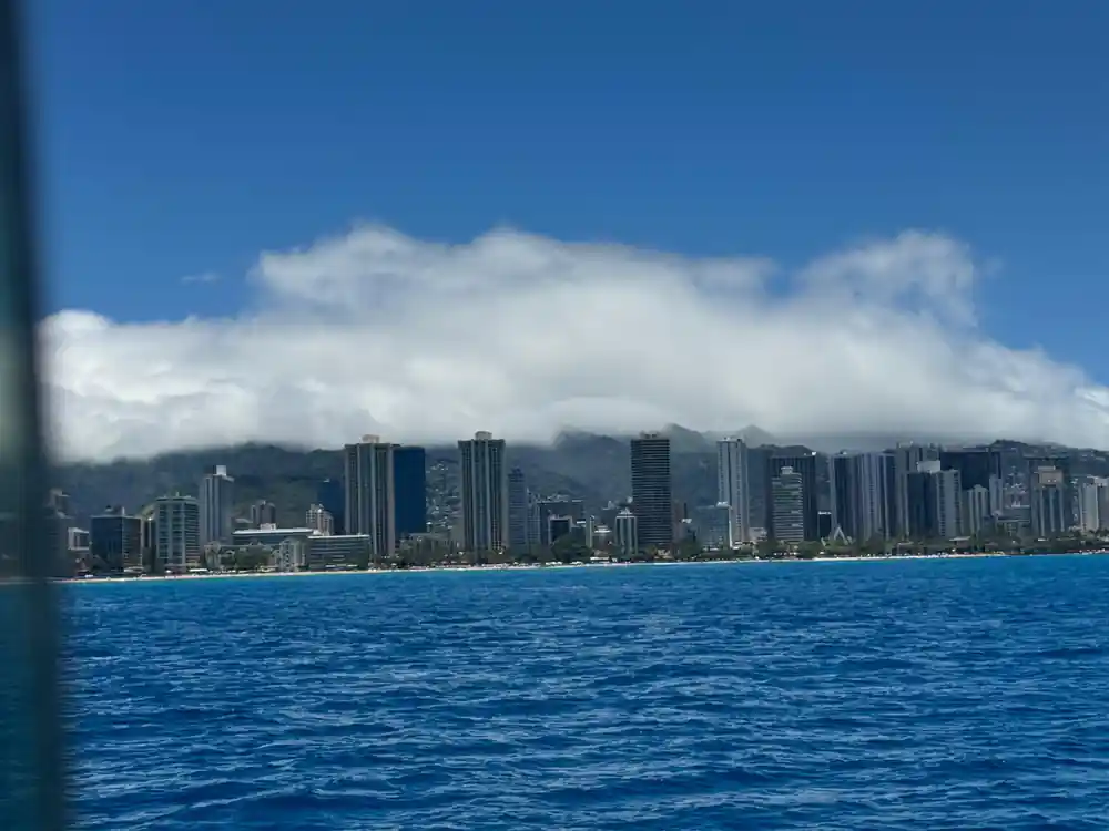 The Honolulu skyline and Diamond Head under cloud, seen from the water