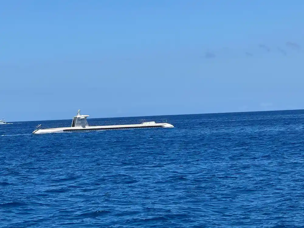 The submarine on the surface on a calm blue sea
