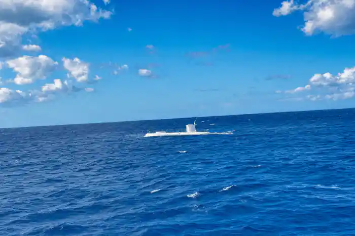 The submarine on the surface in open water off the coast
