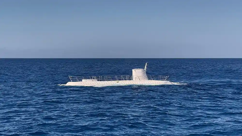 The submarine on the surface under a pale sky